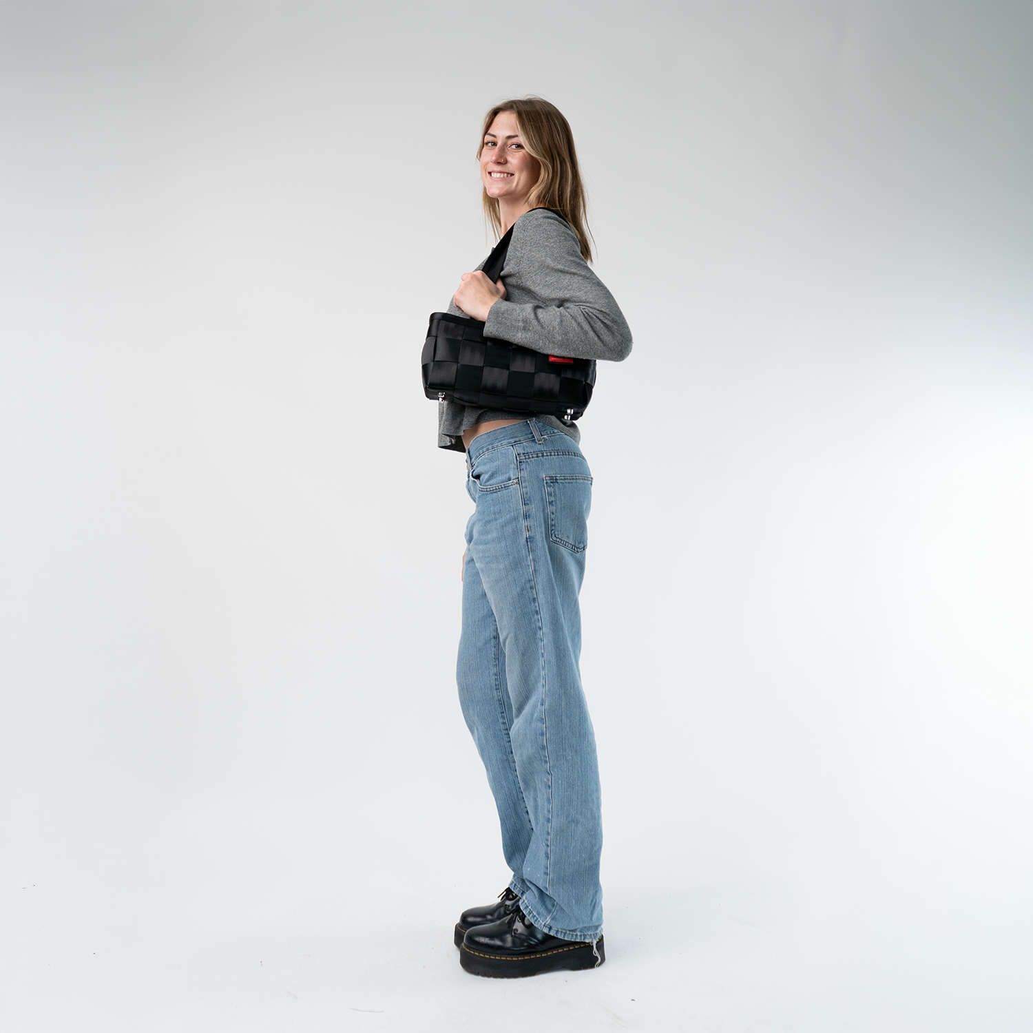 A Satchel in Black on a model's shoulder