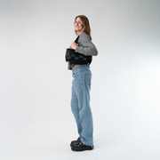 A Satchel in Black on a model's shoulder