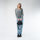 The Woven Petite Tote in Black in a model's hands