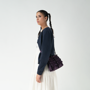 Blackberry Lola Bow Clutch being worn by a model