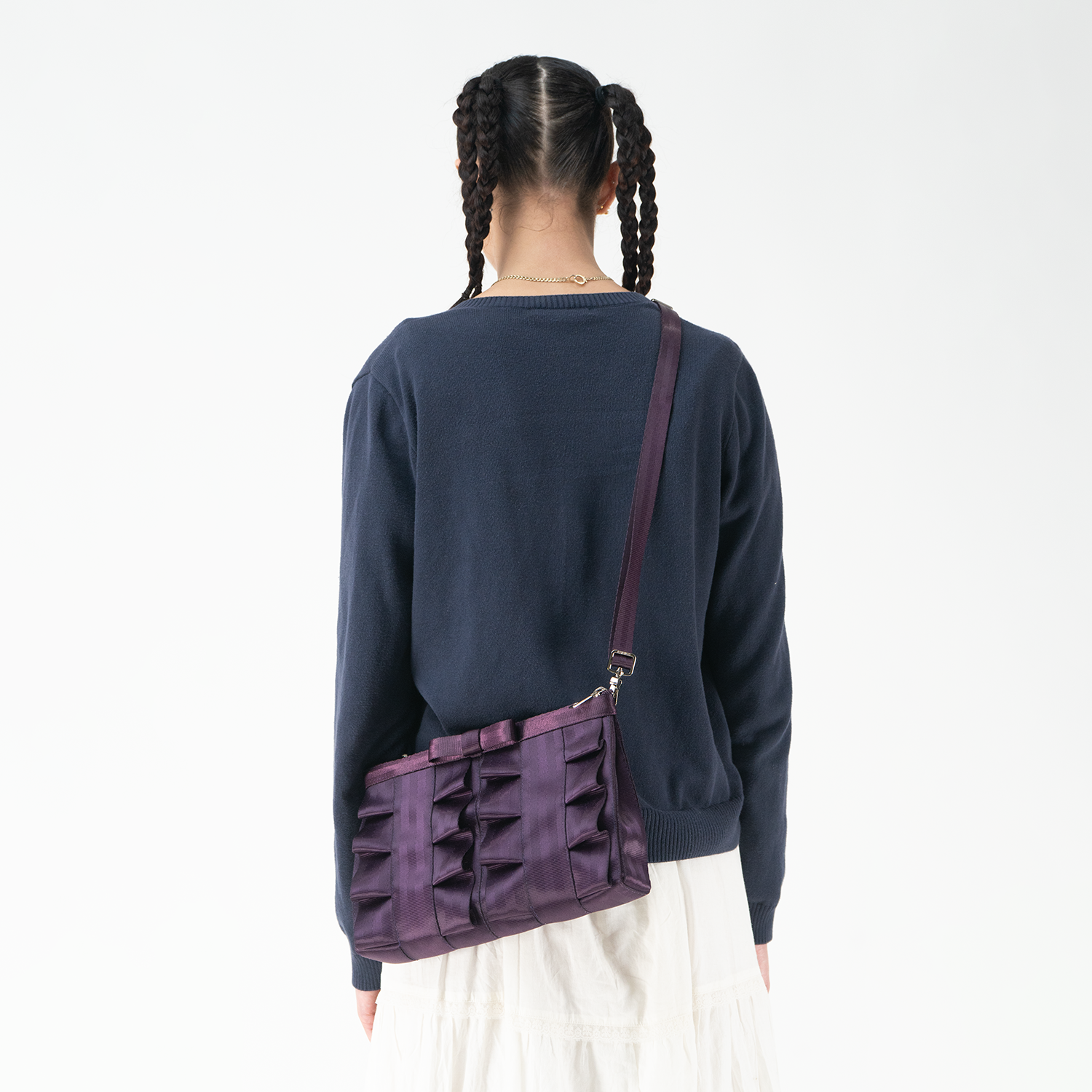 A Blackberry Lola Bow Clutch being worn by a model