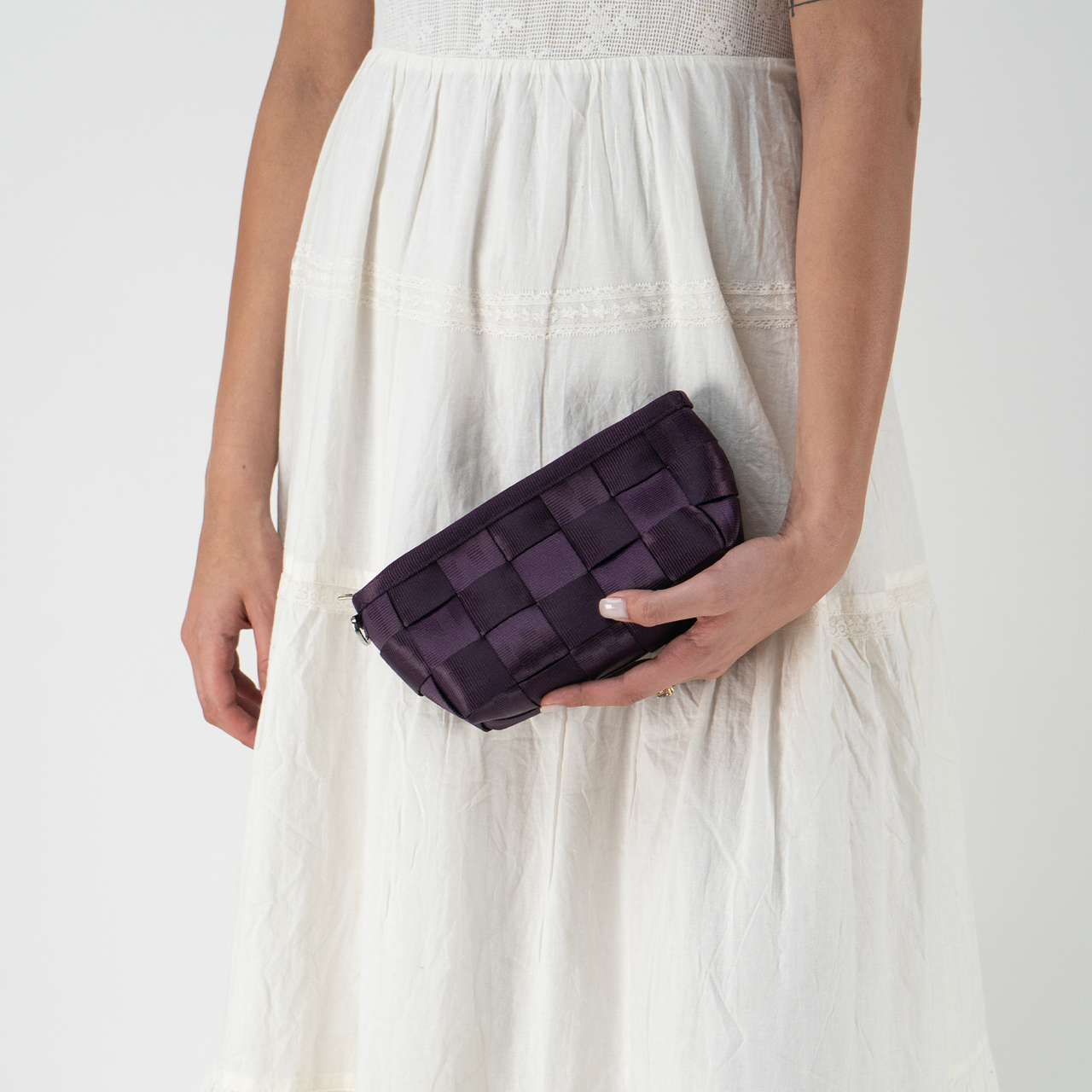 A Blackberry Triangle Makeup Case in a models hand