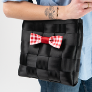 A Red Gingham Seatbelt Bow being used by a model