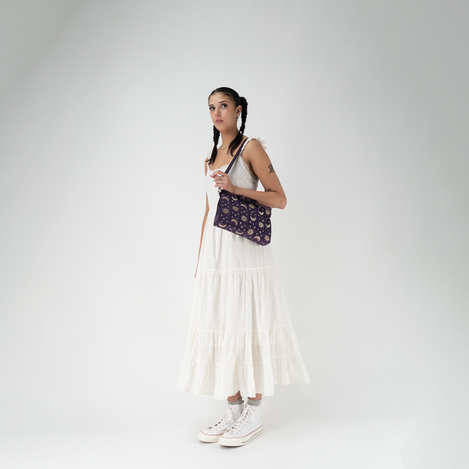 A Celestial Bow Clutch being worn by a model