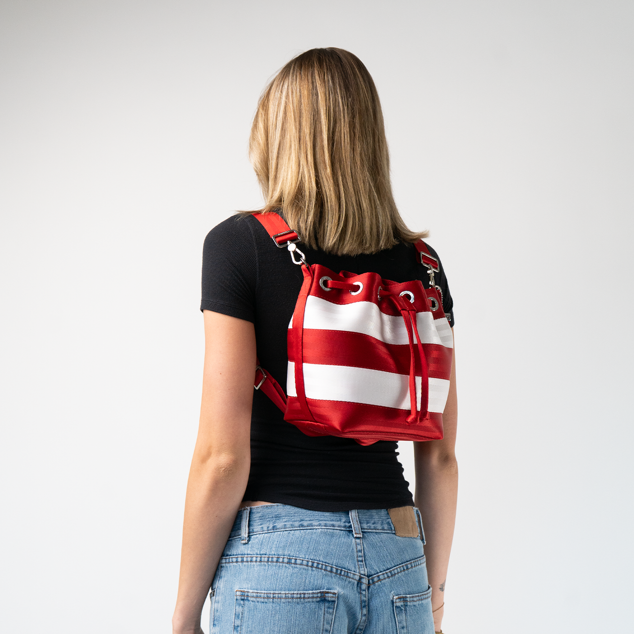 The Candy Cane Medium Parkhopper being worn as a backpack by a model