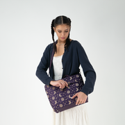 A Celestial Medium Streamline Tote being worn by a model