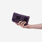 The Classic Wallet in Blackberry being held by a model