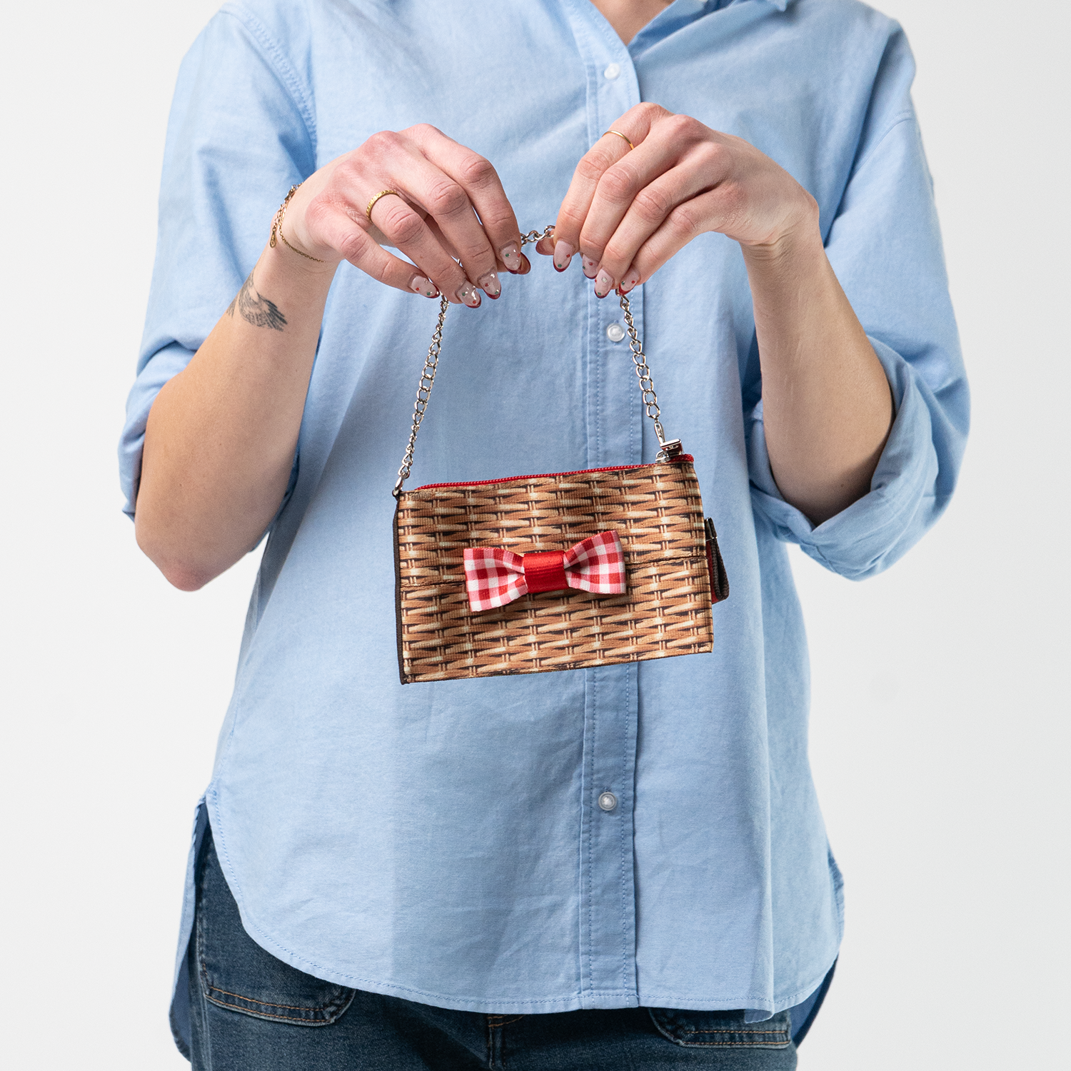 A Picnic Coin Purse being held a model's hands