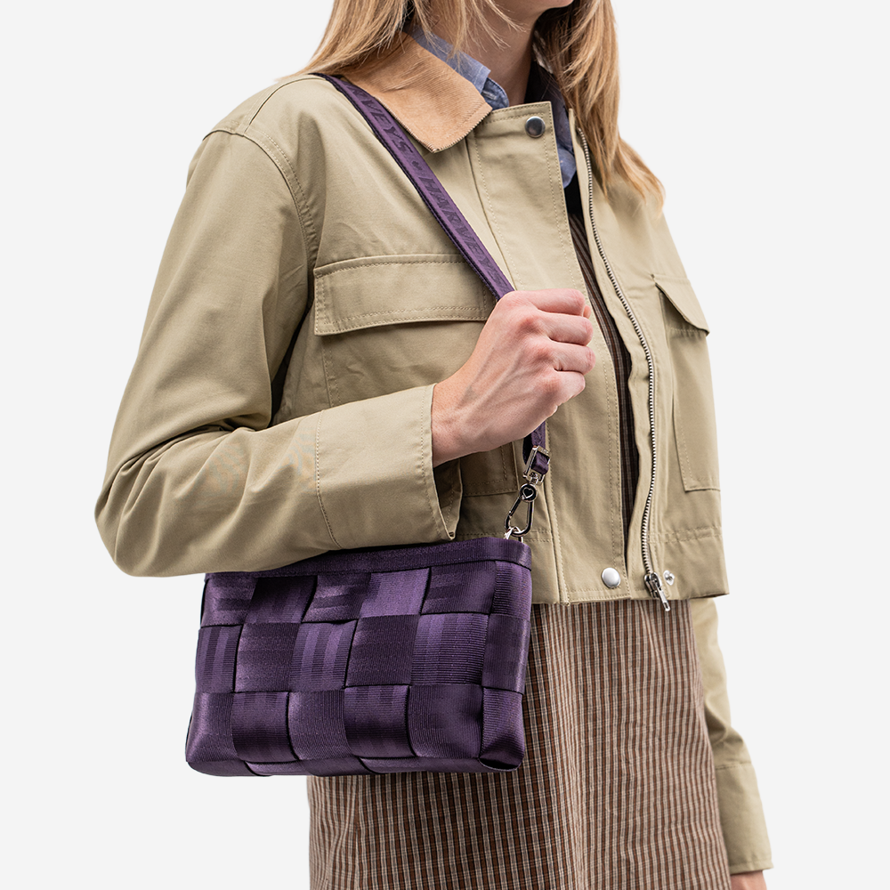 The Convertible Clutch in Blackberry being worn by a model