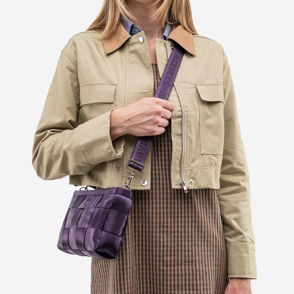 The Convertible Clutch in Blackberry being worn by a model