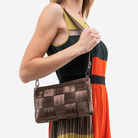 The Convertible Clutch in Espresso being worn by a model