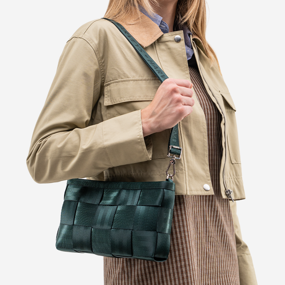 The Convertible Clutch in Nori being worn by a model