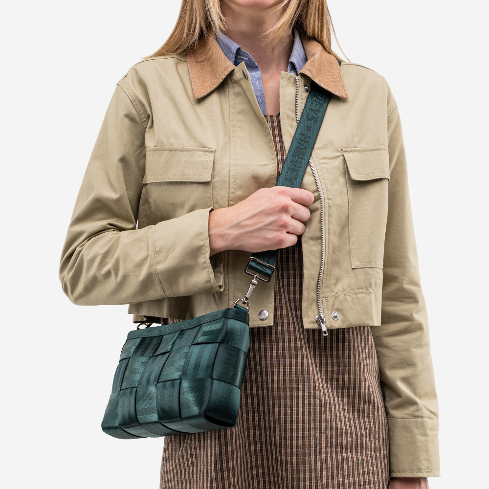 The Convertible Clutch in Nori being worn by a model