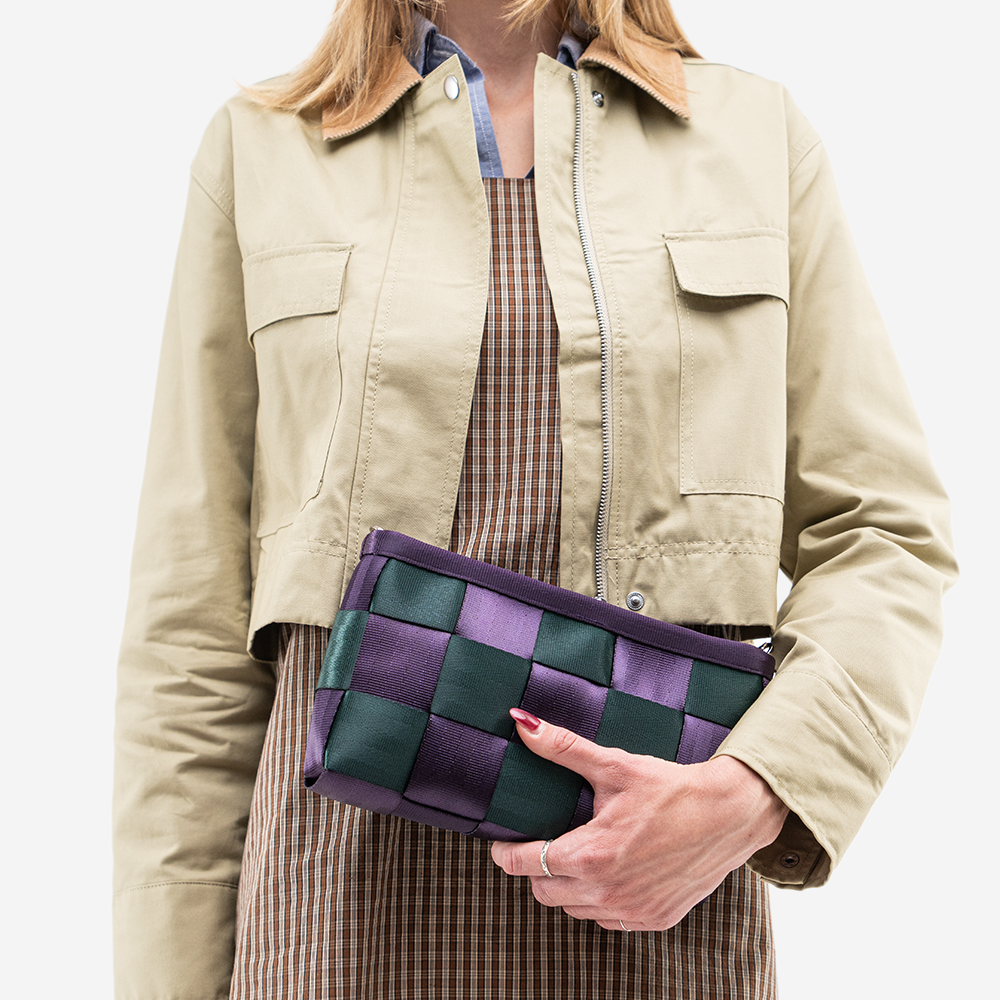 The Convertible Clutch in Poison Ivy being held by a model