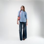 A Red Gingham Convertible Clutch being used by a model