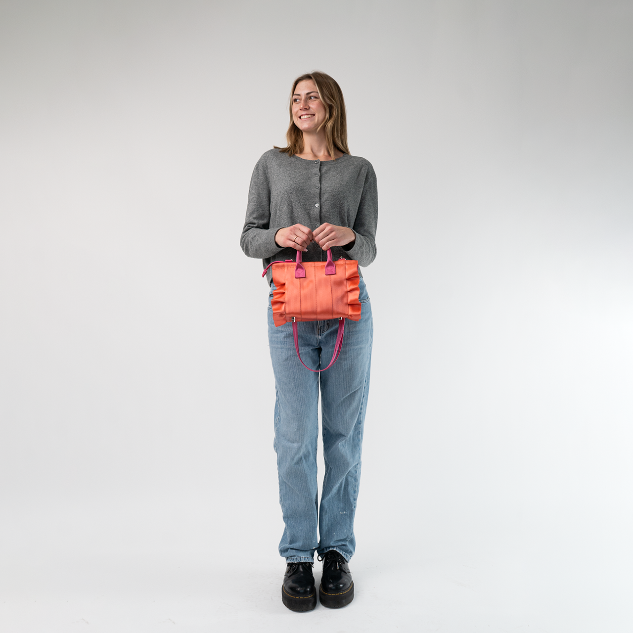 The Coral N Fuchsia Lolita being held in a model's hands