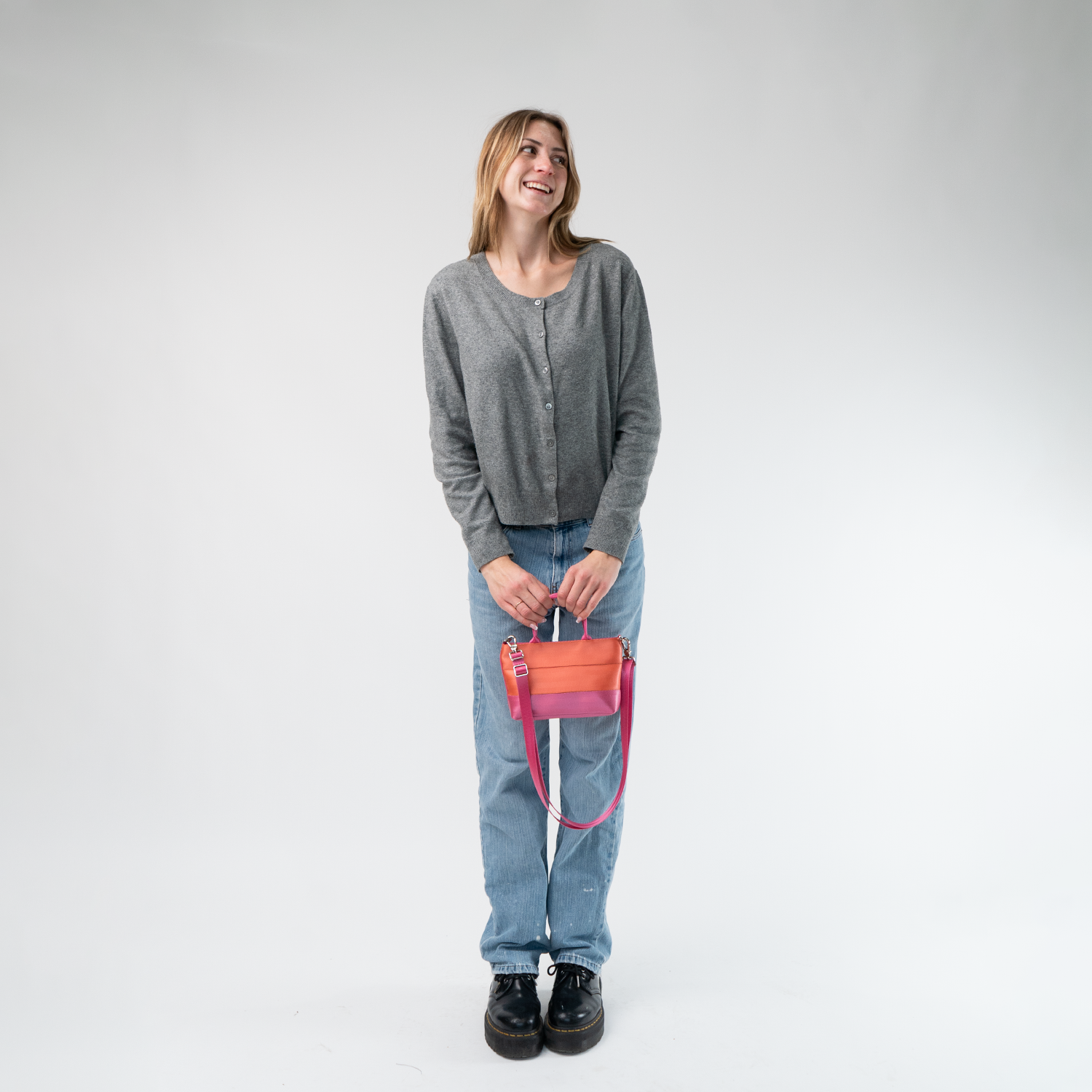 The Coral N Fuchsia Petite Tote being held in a model's hands