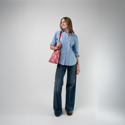 A Red Gingham Crossbody Tote being used by a model