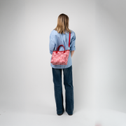 A Red Gingham Crossbody Tote being used by a model