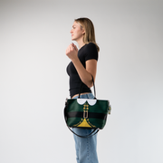 The Elf Mini Streamline Tote being held by a model