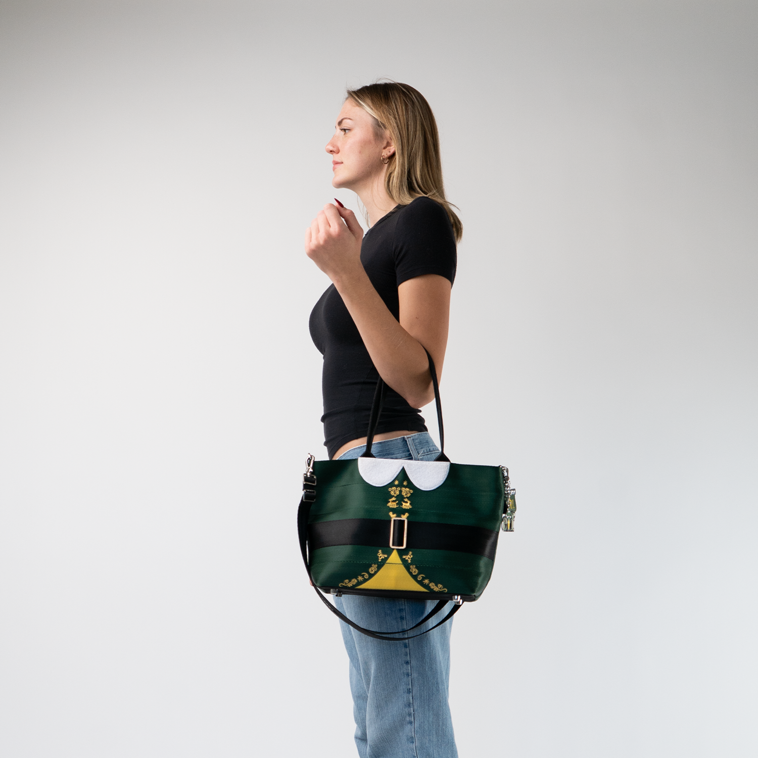 The Elf Mini Streamline Tote being held by a model