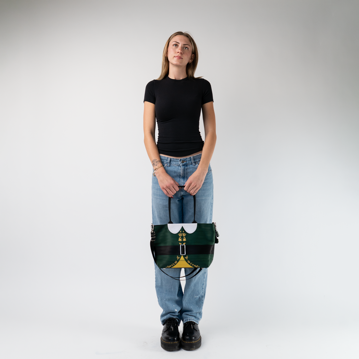 The Elf Mini Streamline Tote being held in a models hands