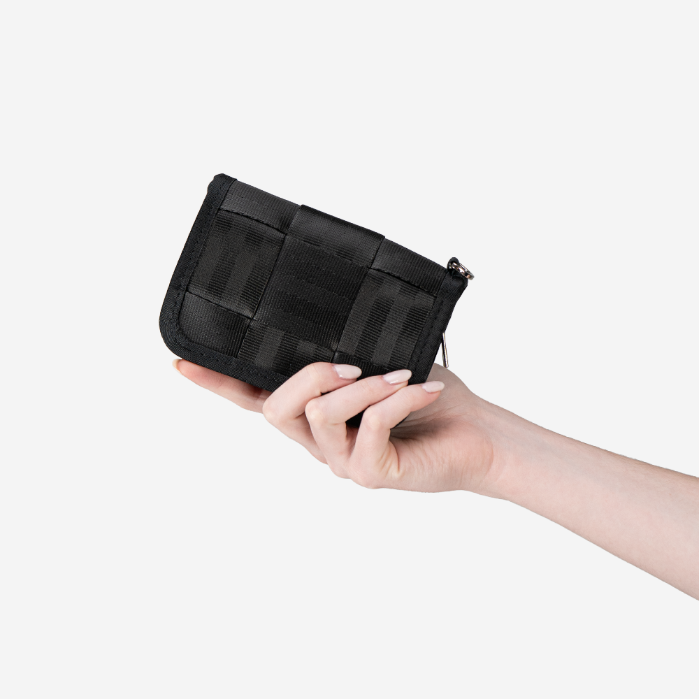 The Black Fun Size Wallet in a models hand