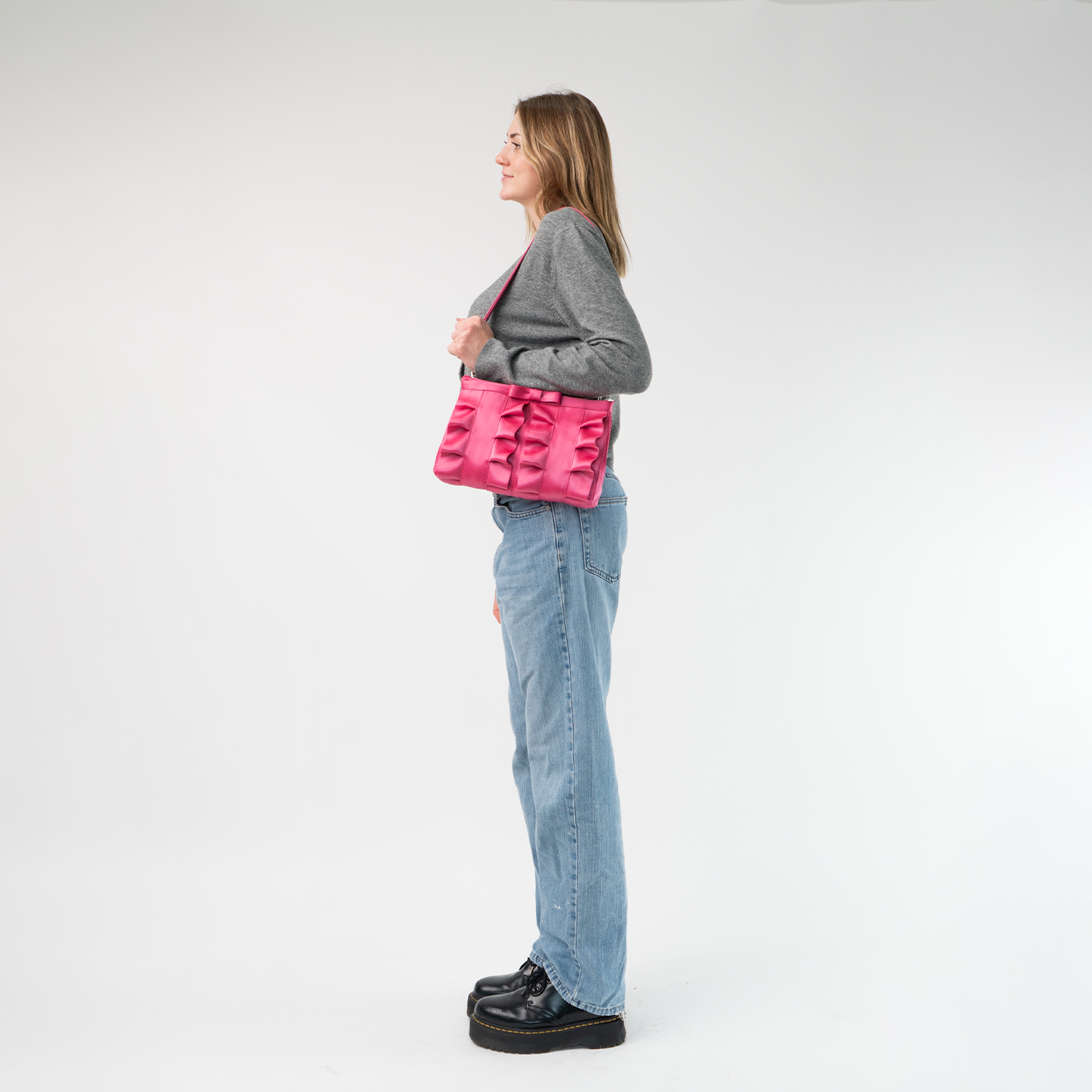 The Fuchsia Lola Bow Clutch being worn by a model