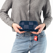 a Classic Wallet in Indigo being held in a Model’s hands