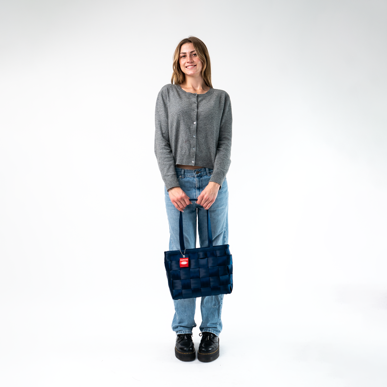 A Large Tote in Indigo being held by a Model