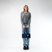 A Satchel in Indigo being held by a Model