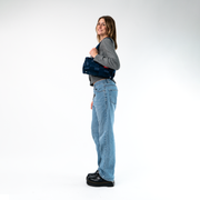A Satchel in Indigo being held by a Model