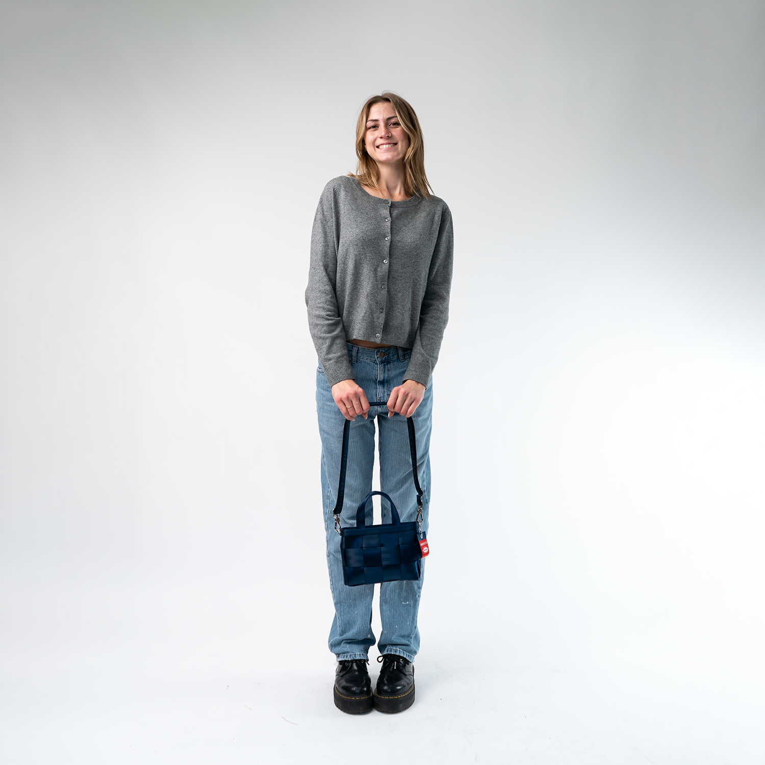 A Woven Petite Tote in Indigo being held by a Model