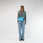 The Maliblue Lola Bow Clutch being worn by a model