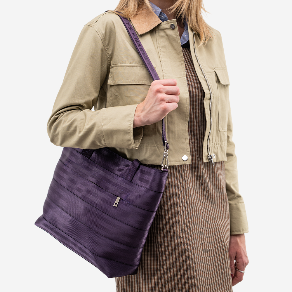 The Medium Streamline Tote in Blackberry being worn by a model