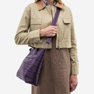 The Medium Streamline Tote in Blackberry being worn by a model