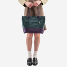 The Medium Streamline Tote in Poison Ivy being held by a model