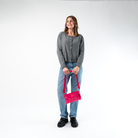 A Hip Pack in Melon being held by a Model