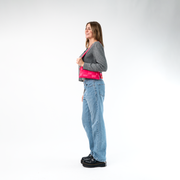 A Hip Pack in Melon being worn by a Model