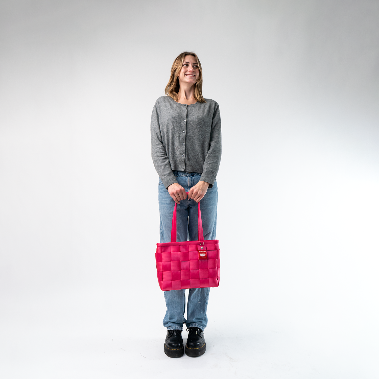 A Large Tote in Melon being held in a Model's hands