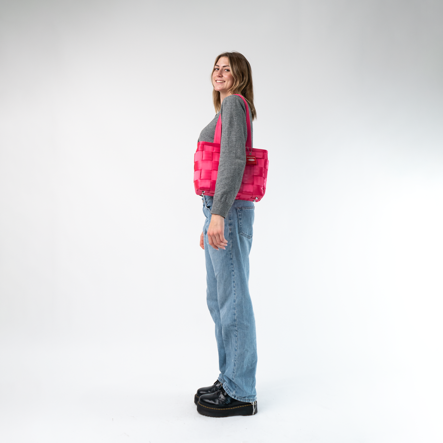 A Large Tote in Melon being worn by a Model