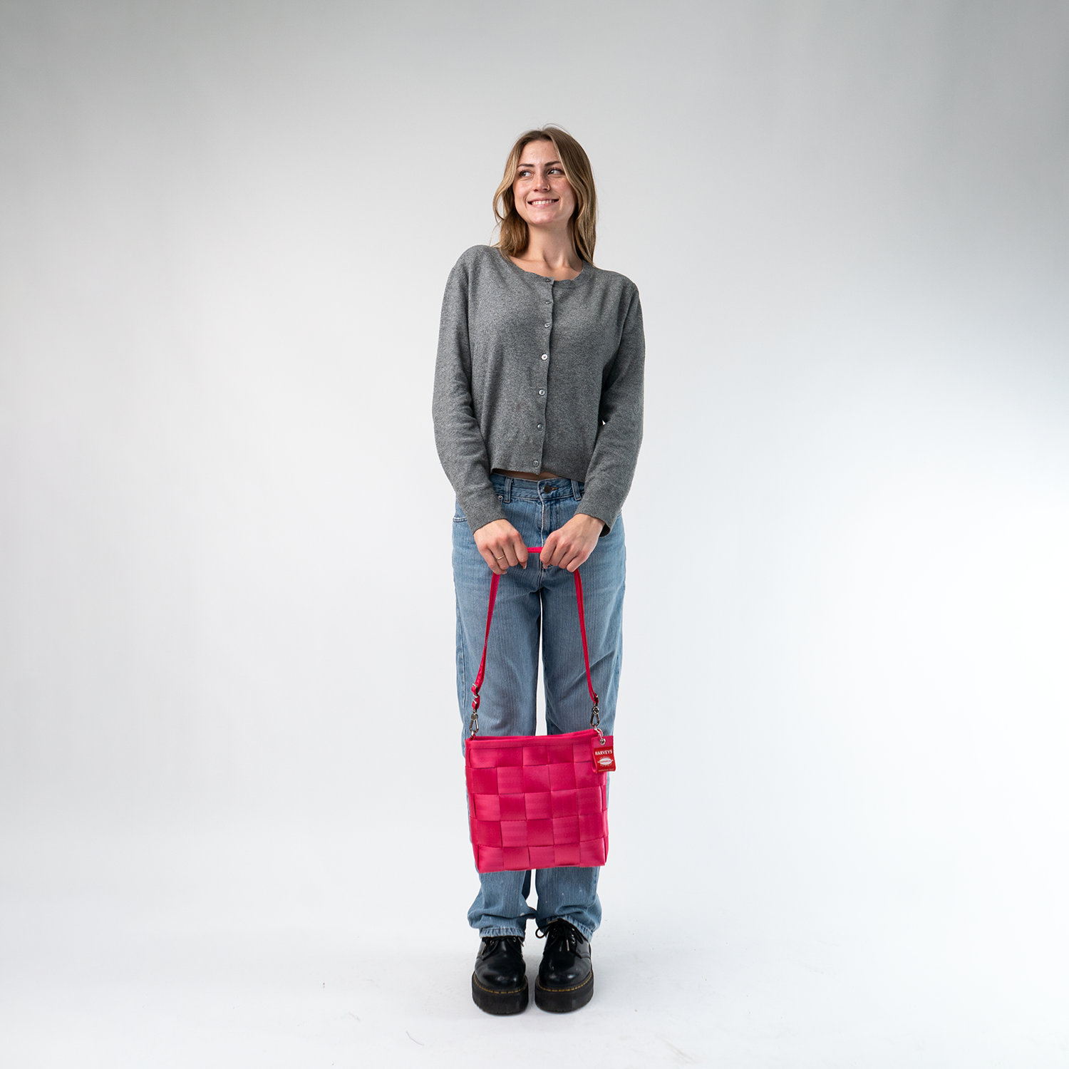 A Mini Messenger in Melon being held by a Model