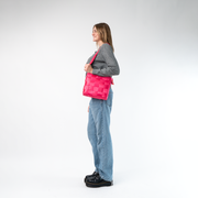 A Mini Messenger in Melon being worn by a Model