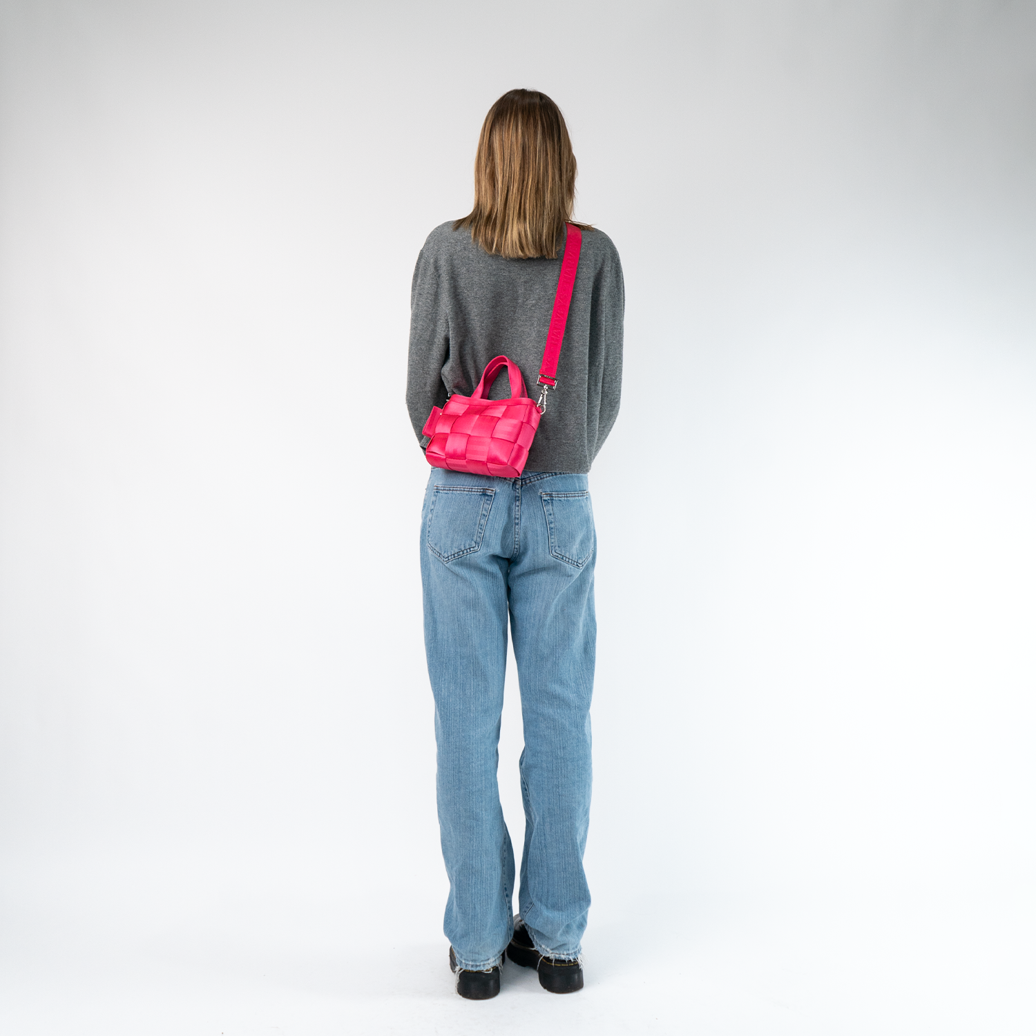 A Woven Petite Tote in Melon being worn by a model