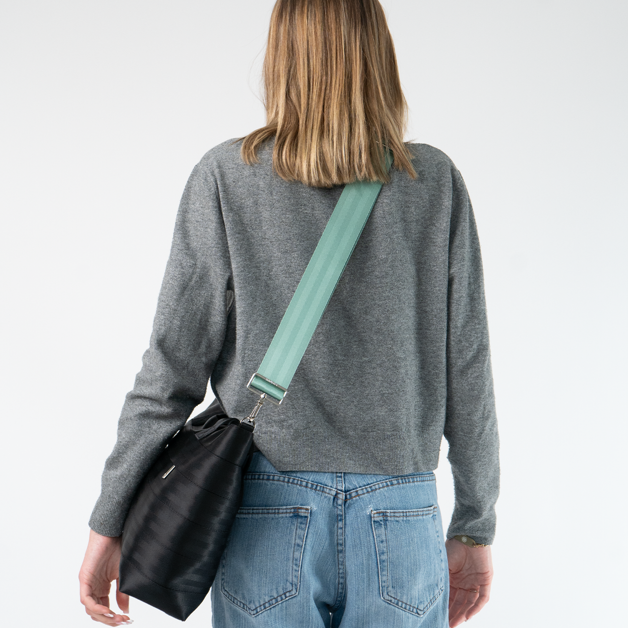The Mint Click N Carry being used on a bag by a model