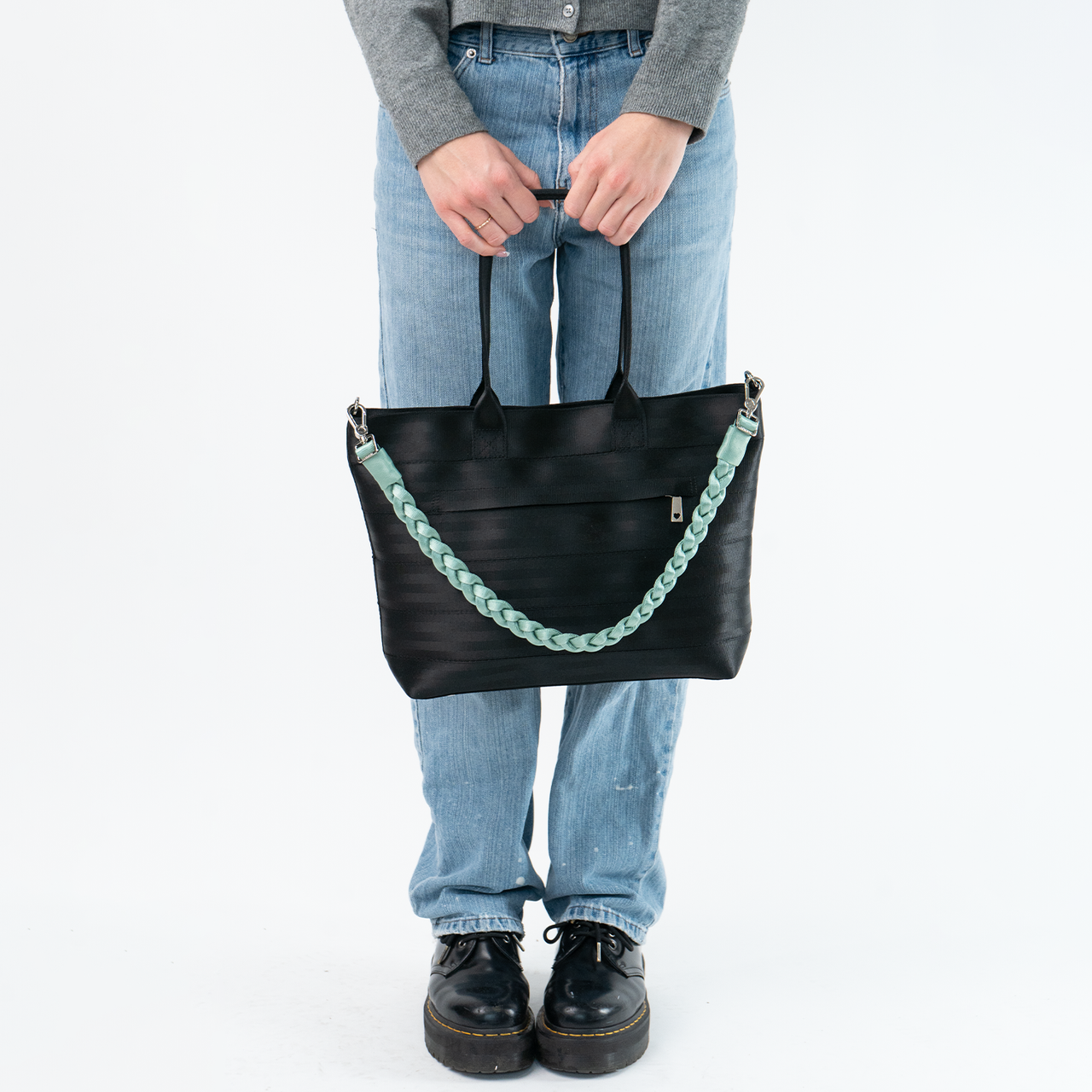 The Mint Sophia Click N Carry being used on a bag by a model