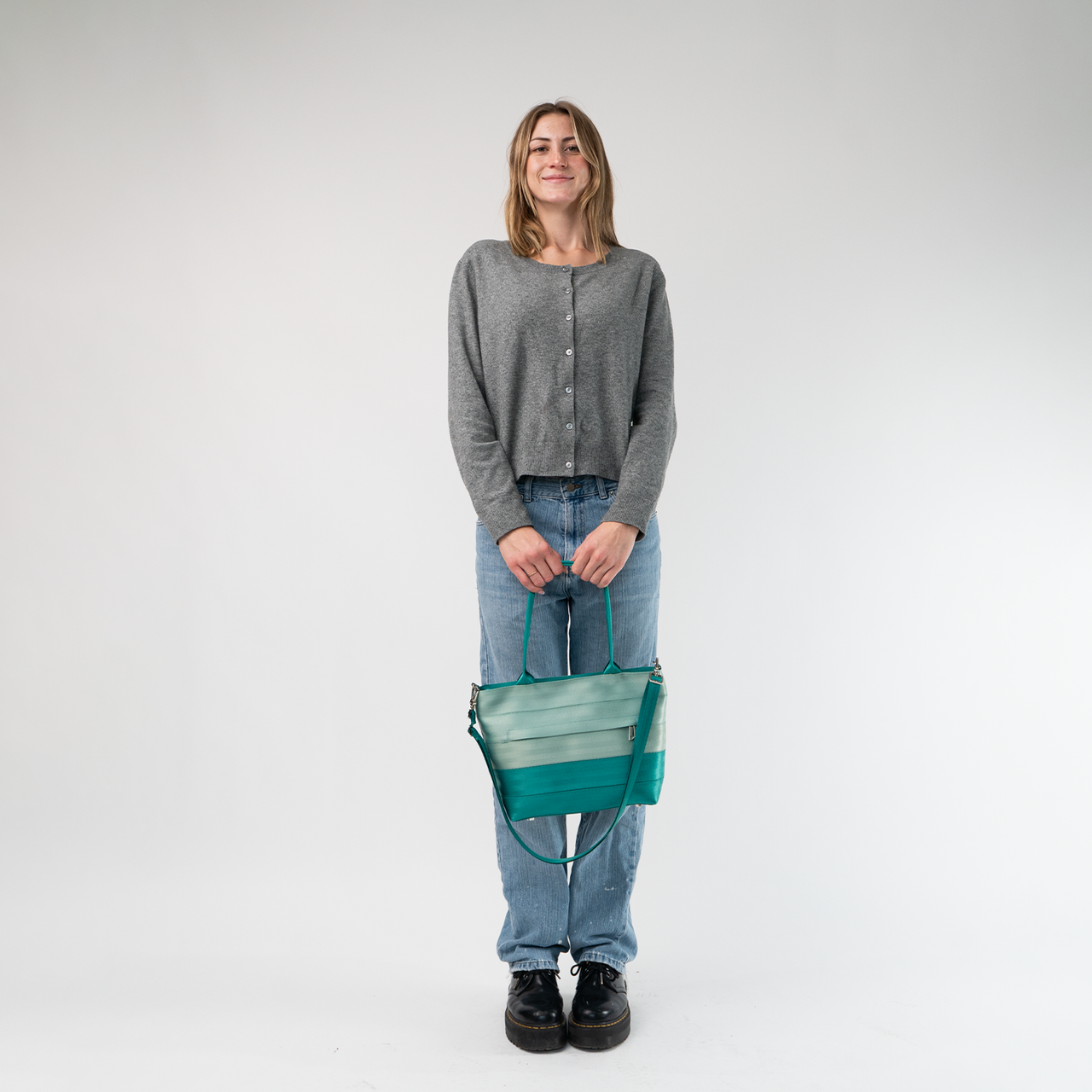 The Mint N Emerald Mini Streamline Tote being held in a model's hands