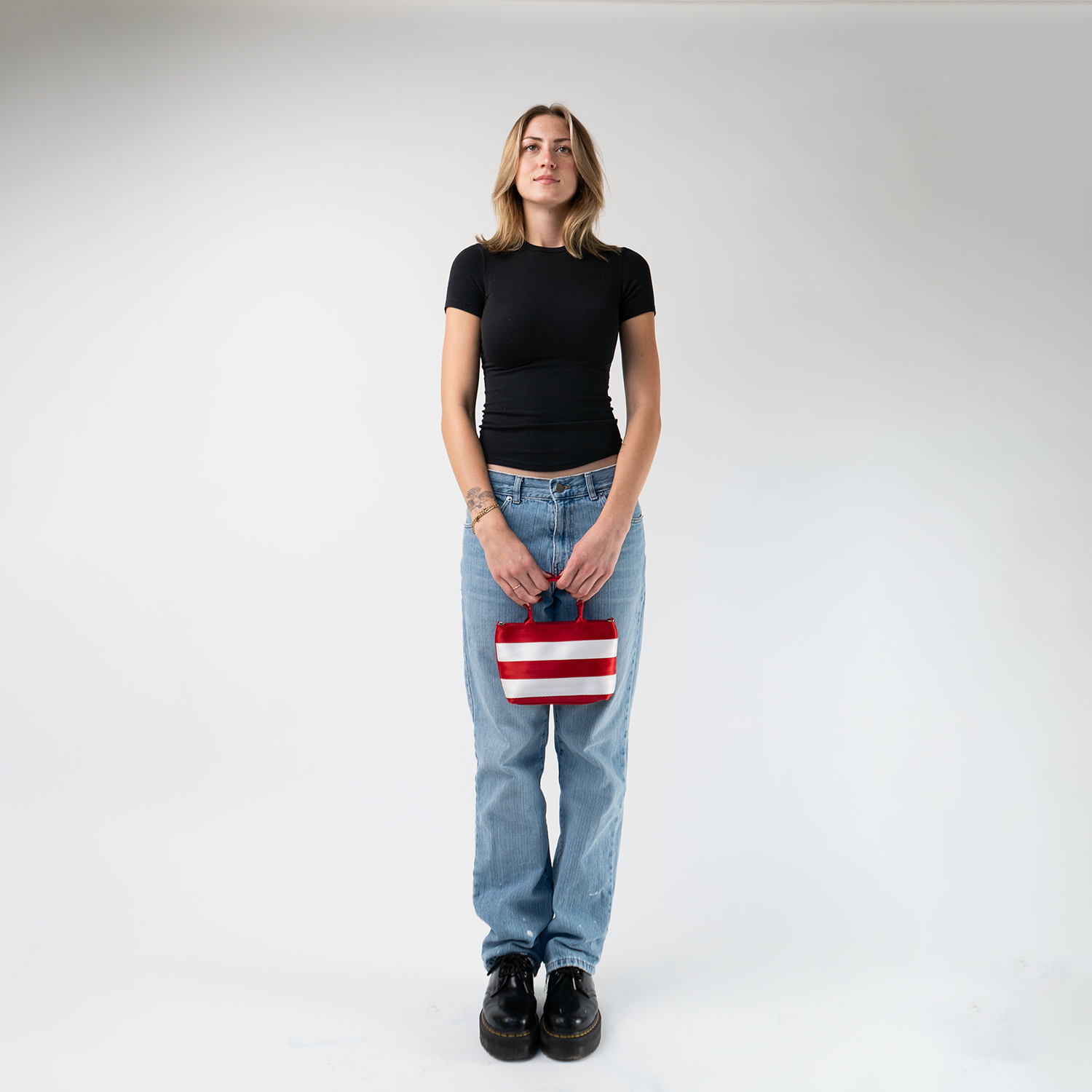 The Candy Cane Petite Tote being held by a model