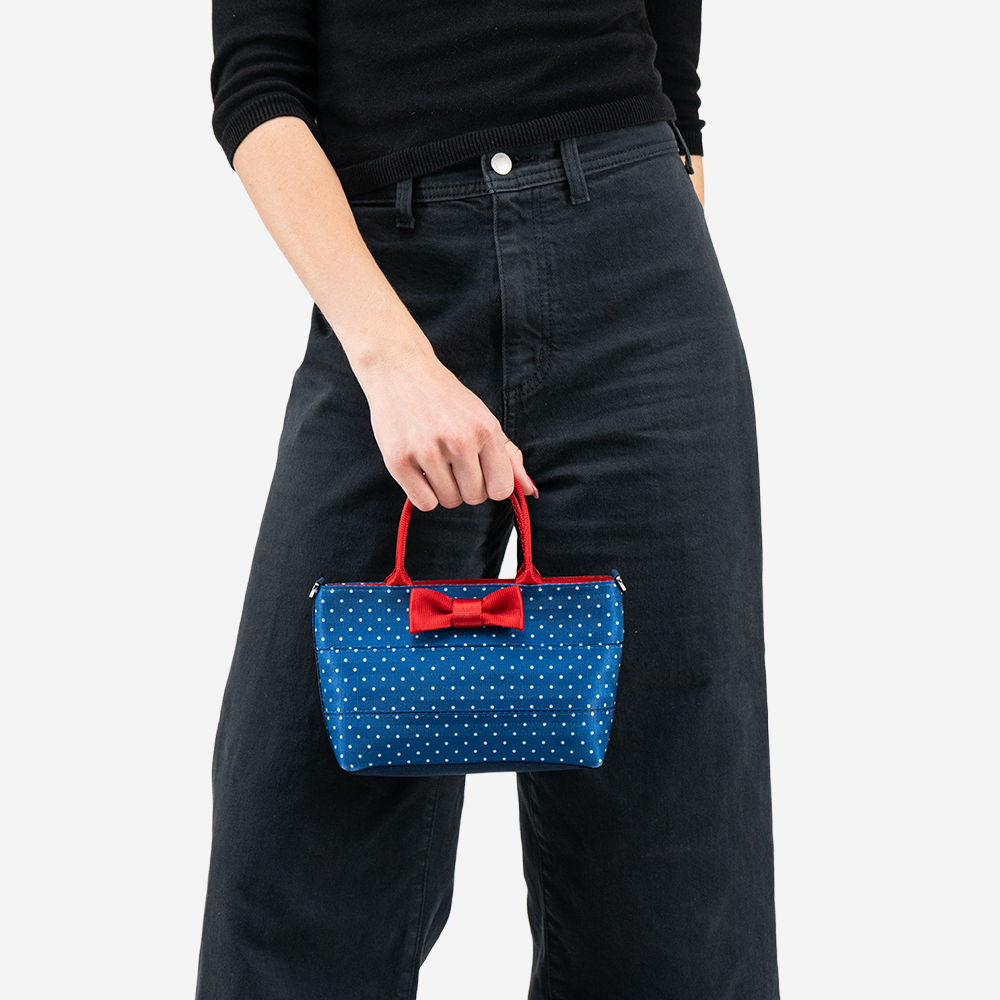 The Scarlet and Blue Dottie Petite Tote being held by a model