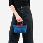 The Scarlet and Blue Dottie Petite Tote being held by a model